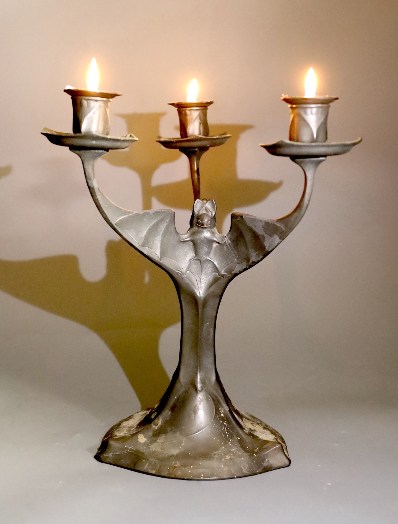 A Kayserzinn pewter three branch 'bat wing' candelabrum, 30cm tall